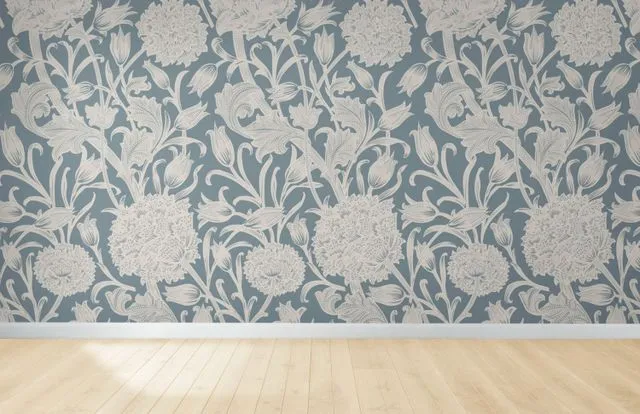 Light blue floral wallpaper above light wood floor.